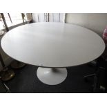 After Eero Saarinen, a tulip type circular dining table, the white laminate top above a white coated