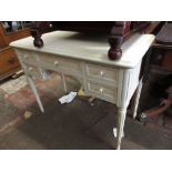 Cream painted kneehole dressing table on fluted supports together with a pair of matching bedside