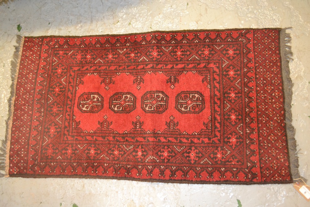 Small rug having four central gols with multiple borders on a wine ground, 3ft x 1.5ft