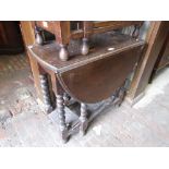 1930's Oak gate leg table on barley twist supports together with a 1930's oak fender stool and an