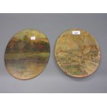 Pair of early 20th Century oval terracotta plaques painted in oils, snowy village scene and summer
