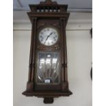 Early 20th Century Continental beechwood Vienna type wall clock with a spindle gallery above a