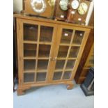 Pair of Arts and Crafts oak two door glazed bookcases on bracket feet 44ins wide x 36ins high x