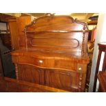 Small Victorian mahogany serpentine fronted chiffonier with a shelf back and two panelled doors,