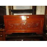 20th Century Chinese carved exotic hardwood trunk having hinged cover with brass clasp and lock