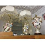 Pair of bisque porcelain figural table lamp bases with gilt metal mounts, silk shades having