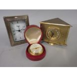 Looping gilt metal eight day travel clock in a leather case, together with a French revolving desk