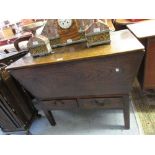 18th Century oak dough bin, the plank hinged top above two short drawers with brass swan neck