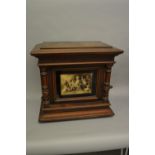 19th Century walnut cased upright polyphon, the glazed door decorated with a print of children