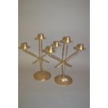 Pair of white metal Continental stylised three branch candelabra on circular weighted bases