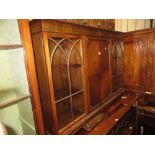 1920's Mahogany bookcase with a moulded top above a centre panelled door flanked by two glazed doors