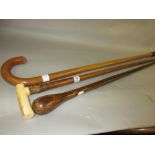 19th Century walking stick with carved ivory handle together with two other walking sticks