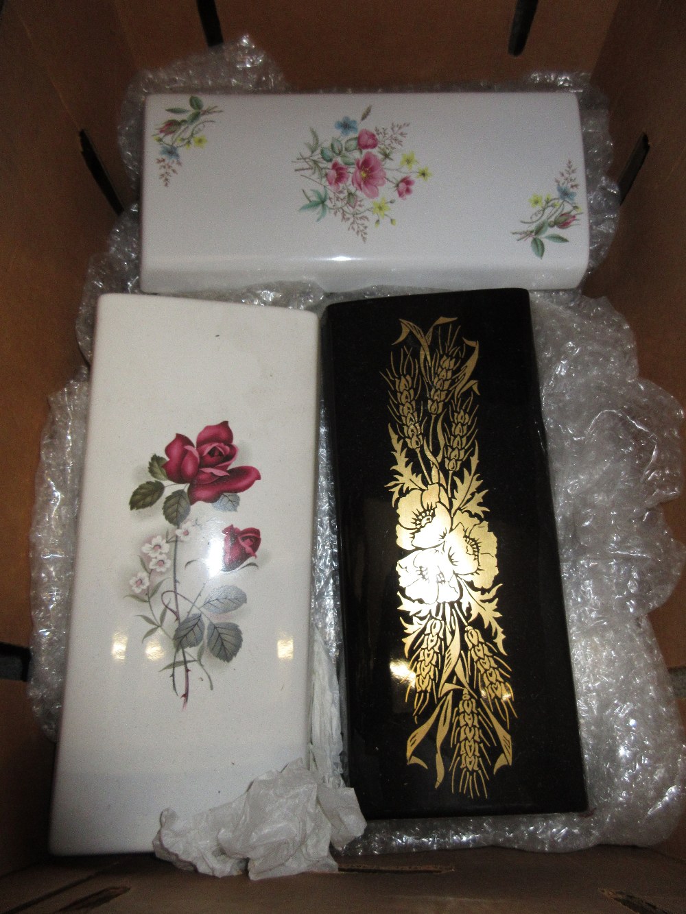 Box containing a quantity of various 20th Century porcelain wall pockets with floral decoration