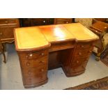 Victorian mahogany kneehole desk, the tooled leather inset top above an arrangement of nine
