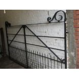 Modern good quality black painted wrought iron double gate having scroll work detailing and integral