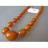 Graduated amber bead necklace, overall length 52cms, largest bead approximately 25mm x 20mm,
