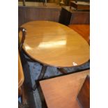 Mahogany twin pedestal dining table with a single central extra leaf (the table closing to form a