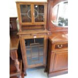 Oak Arts and Crafts style narrow bookcase with two leaded glazed doors above a single astragal