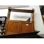 Late Victorian oak wall bracket with open shelves above two panel doors and Gothic style pierced