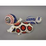 Three Royal Crown Derby paperweights in the form of a snail, a pig and an Artic Fox