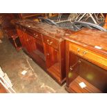 Reproduction mahogany open bookcase having three drawers with brass swan neck handles above