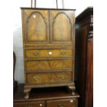 20th Century walnut side cabinet with a pair of doors above brushing slide and three graduated