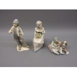 Lladro figure of a child with dog and puppies, together with two other Lladro style figures
