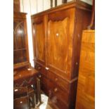 Victorian mahogany linen press with a pair of arched doors above two short and two long drawers on a