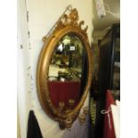 Oval gilt framed bevelled edge wall mirror with triple candle holder bracket