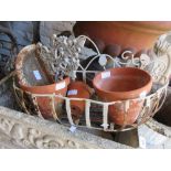 Small painted wrought iron wall basket, a small cast iron wall pocket and three terracotta flower