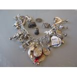 Silver charm bracelet together with four loose charms