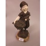 Reproduction bronze and ivorine figure of a girl carrying a basket of flowers after Chiparus, 10.