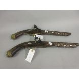 Pair of Eastern mother of pearl and wire inlaid reproduction flintlock pistols with brass mounts