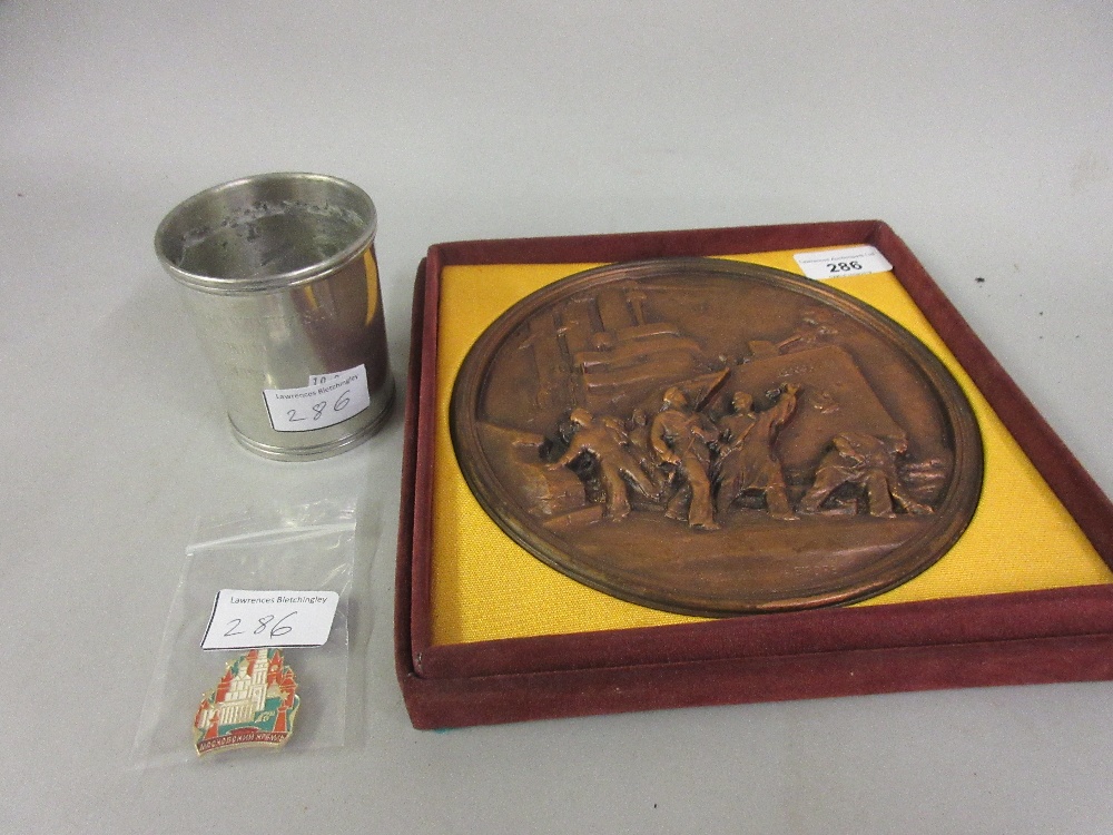 Cased resin plaque, an American University of London beaker and an enamel badge (from the Harold