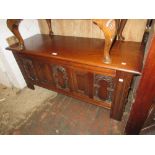 Reproduction oak coffer in 17th Century style with a carved panel front