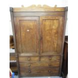 19th Century Irish mahogany linen press, the shaped top above two panelled doors with two short