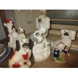 Three various Staffordshire pottery figures of spaniels together with three other Staffordshire