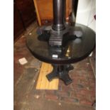 Pair of black ash circular glass topped occasional tables on platform bases, together with a