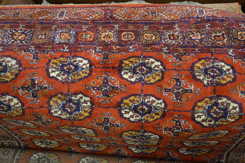 Persian style carpet having lines of gols with multiple borders and two smaller similar machine