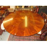 Good quality reproduction circular mahogany Jupe type extending dining table, the feathered mahogany