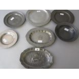 Seven pewter plates, dishes and bowls, one decorated with a crown and lizard