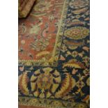 Agra carpet of all-over floral design on a burgundy ground with multiple borders, 116ins x 160ins (