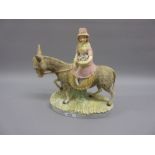 19th Century bisque polychrome figure of a girl riding a donkey