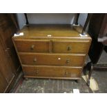 20th Century oak chest of three long drawers with brass knob handles raised on turned supports,