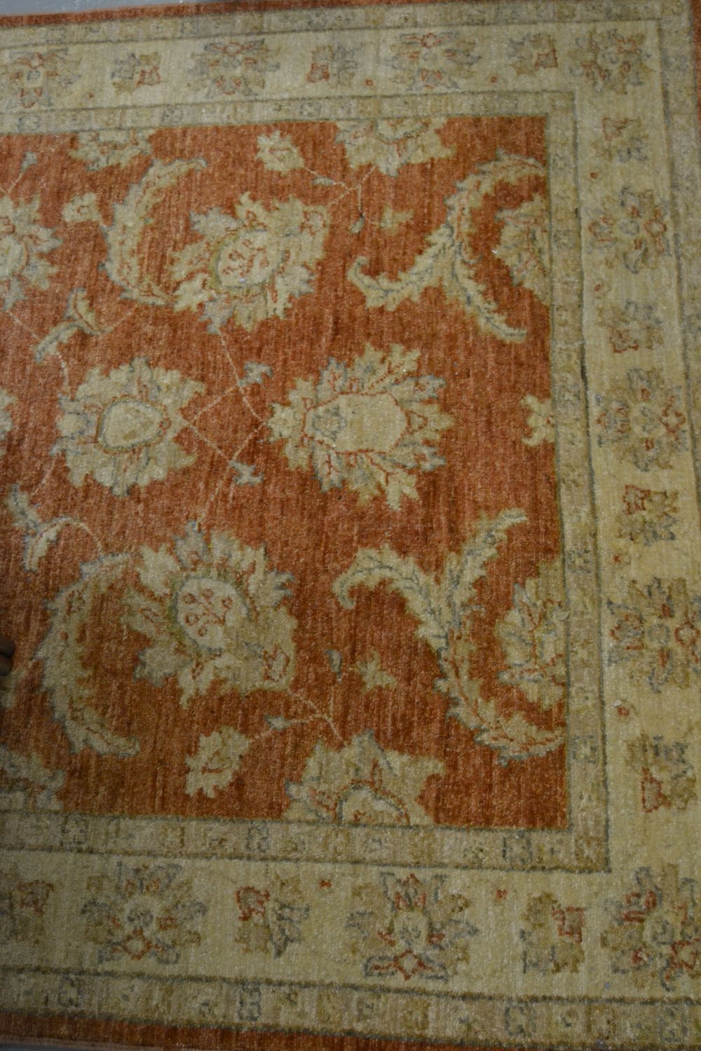 Afghan Ziegler rug with an all-over floral design on a brick red ground, 69ins x 50ins