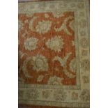 Afghan Ziegler rug with an all-over floral design on a brick red ground, 69ins x 50ins