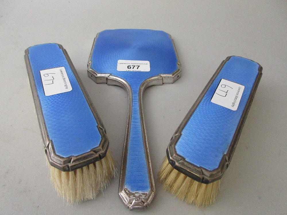 Silver and blue translucent enamel three piece dressing table set comprising: mirror and two brushes