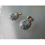 Pair of 9ct gold oval aquamarine and diamond cluster drop earrings