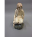 Copenhagen porcelain figure of a girl seated on a rock