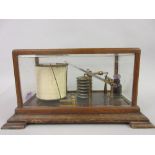 F. Darton and Co. gilt brass barograph housed in an oak and glazed cabinet